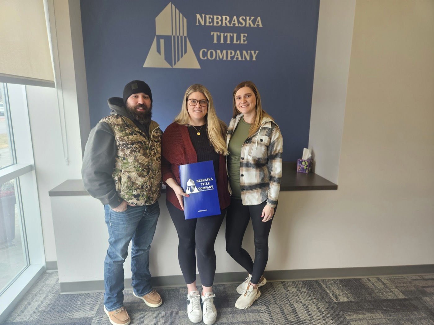 Sydney Hrouda with clients at closing at Nebraska Title Company