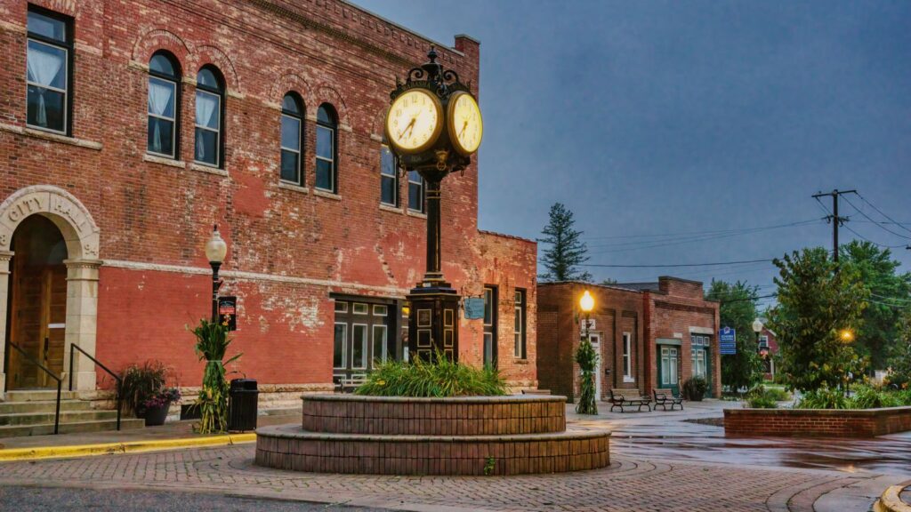 Charming brick building with unique street clock in Wabasha, Minnesota. Urban historic scene at dusk.